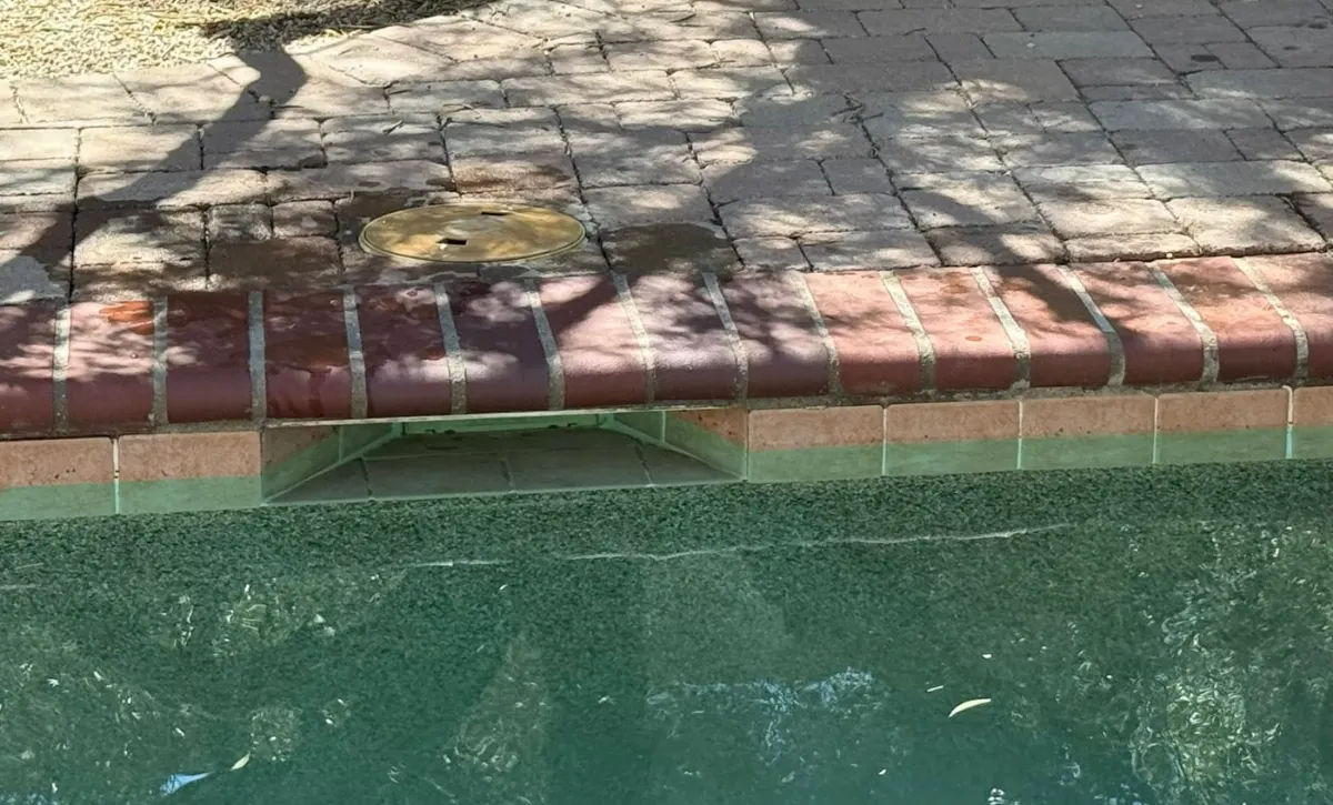Calcium scale on a spa spillway edge in Tucson